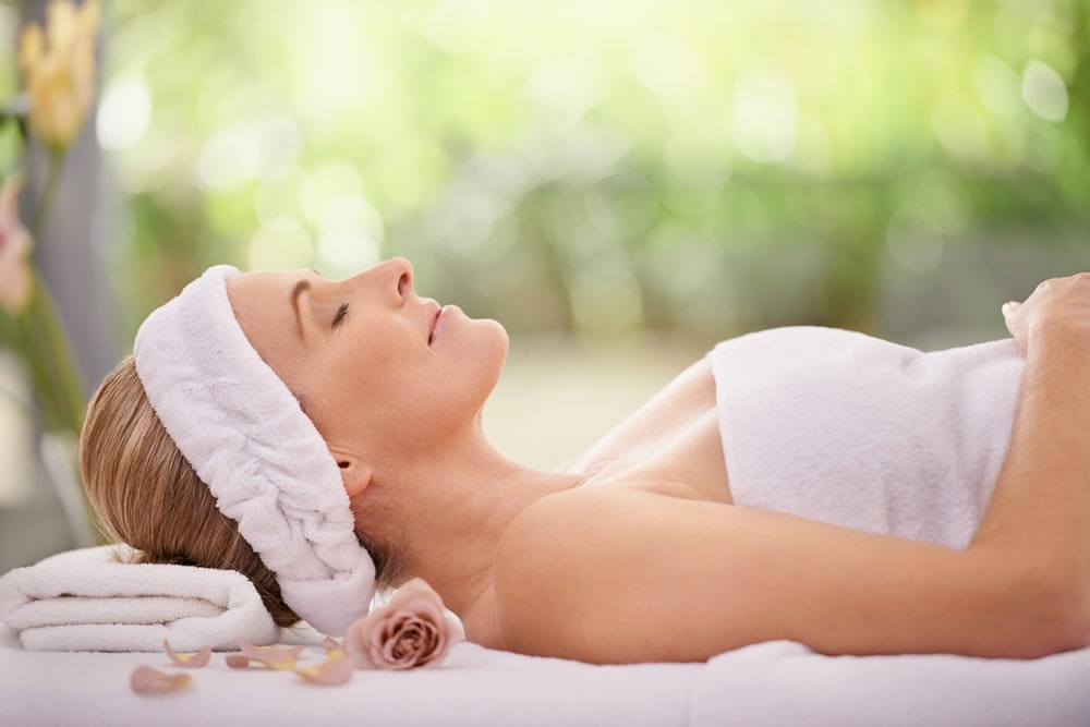 A woman lying on her back during a body massage in Atlanta