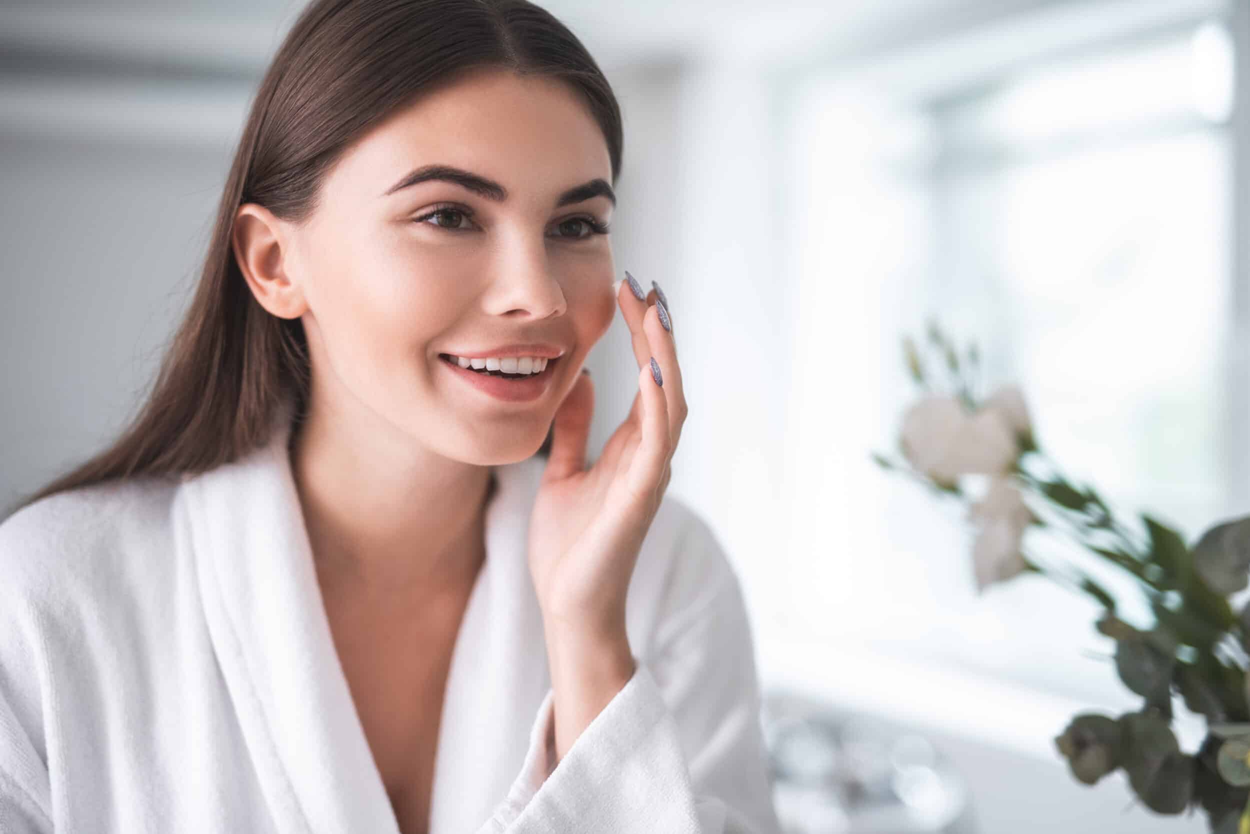 A woman looking in the mirror after a PDO thread lift in Alpharetta
