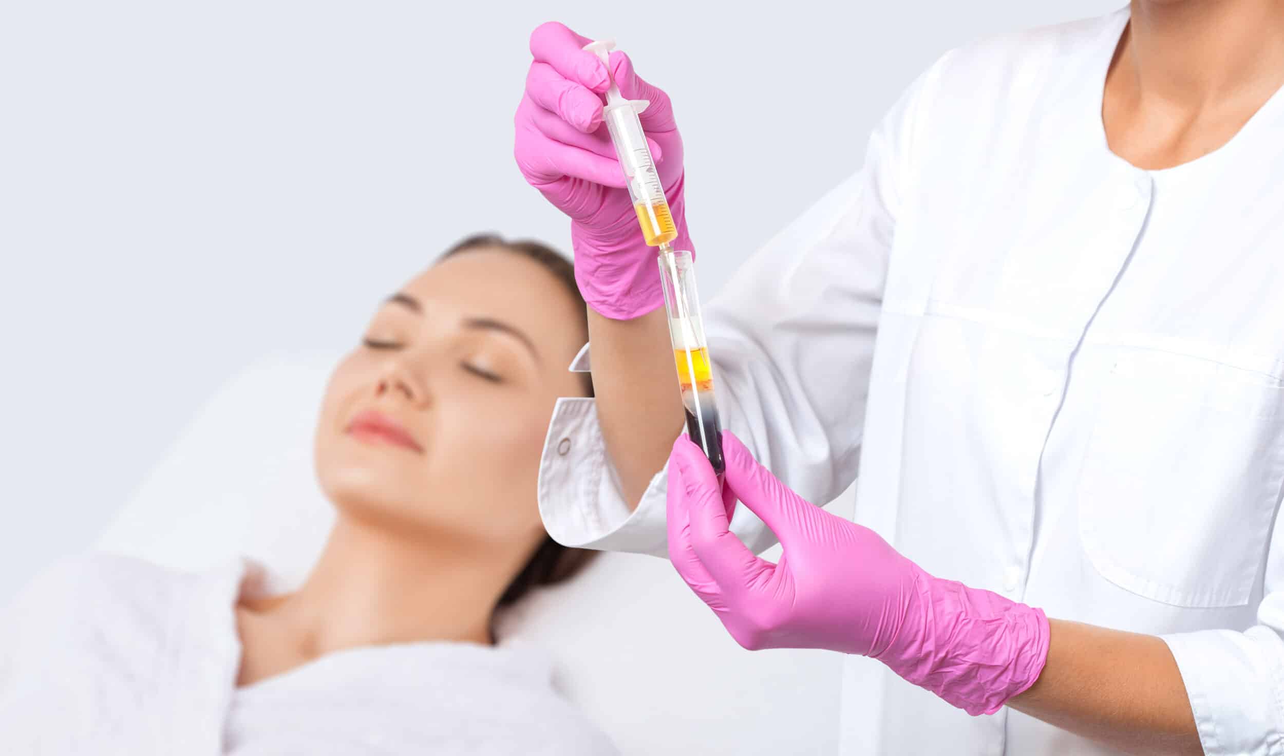 A woman collecting platelet-rich plasma for injectable PRP treatments