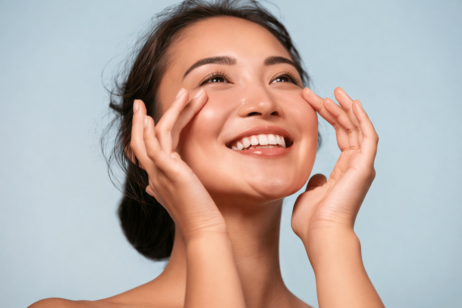 A woman smiling and touching her cheeks after PRP in Buckhead