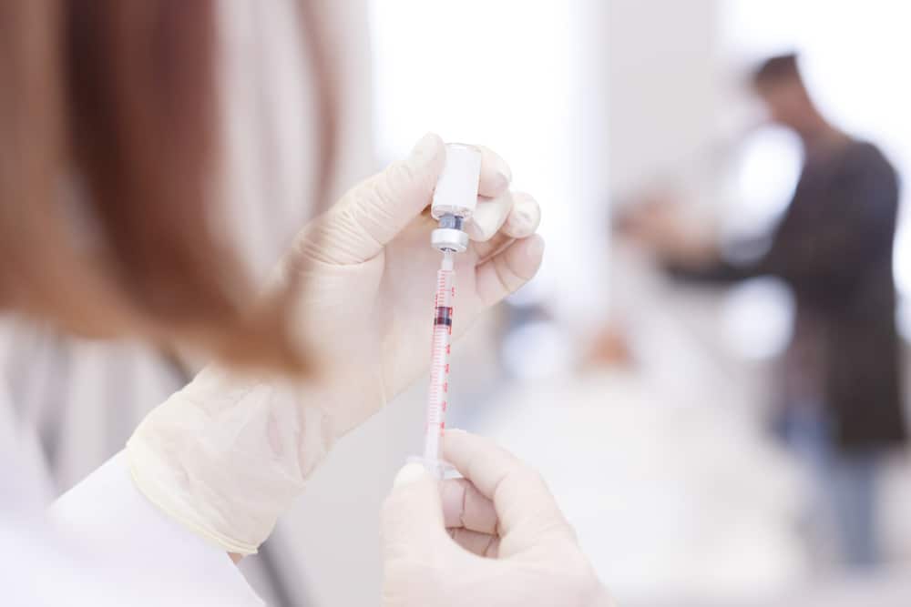 Doctor preparing a vitamin b12 shot Doctor preparing a vitamin b12 shot
